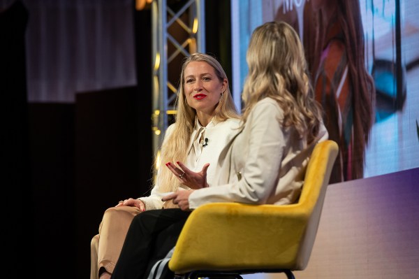 Two executives having a conversation on stage