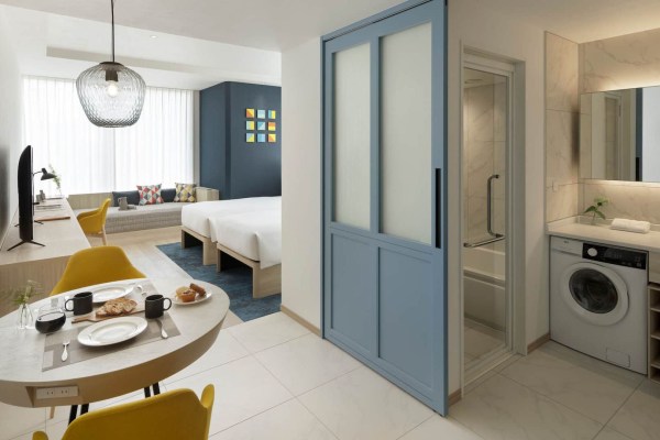 interior of a hotel room showing beds and the bathroom