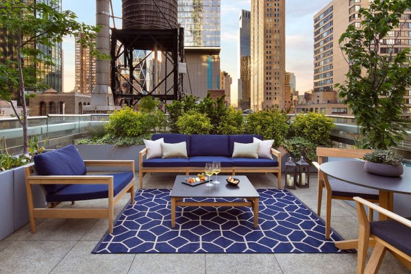 a patio with a couch and chairs.