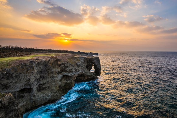 view of a coastline, water, and a sunset