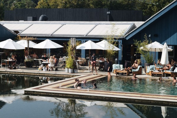 people milling around and in an outdoor pool