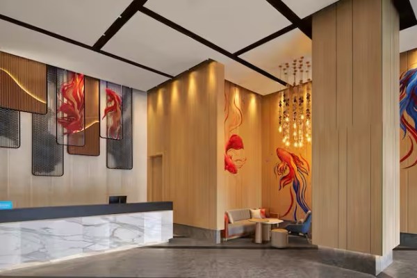 A well lit hotel lobby with wooden paneling and bold artwork