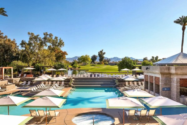 View of a hotel pool and greens beyond it.