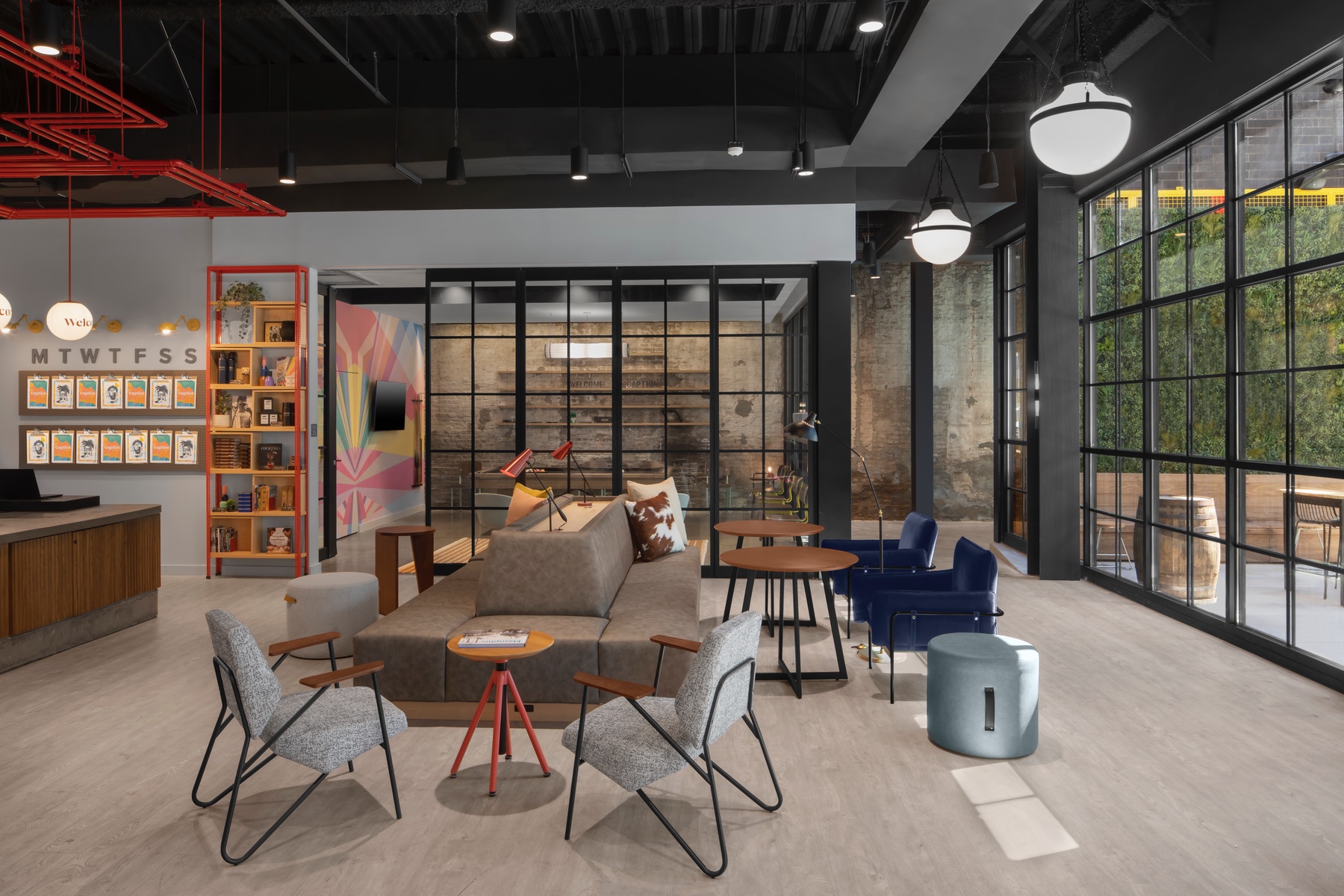 a modern hotel lobby with high ceilings and tables and chairs.