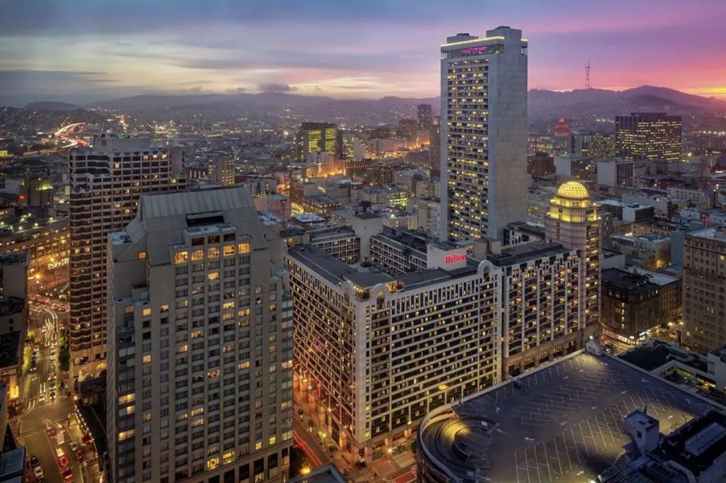 view of a tall hotel in san francisco from the air at sunset