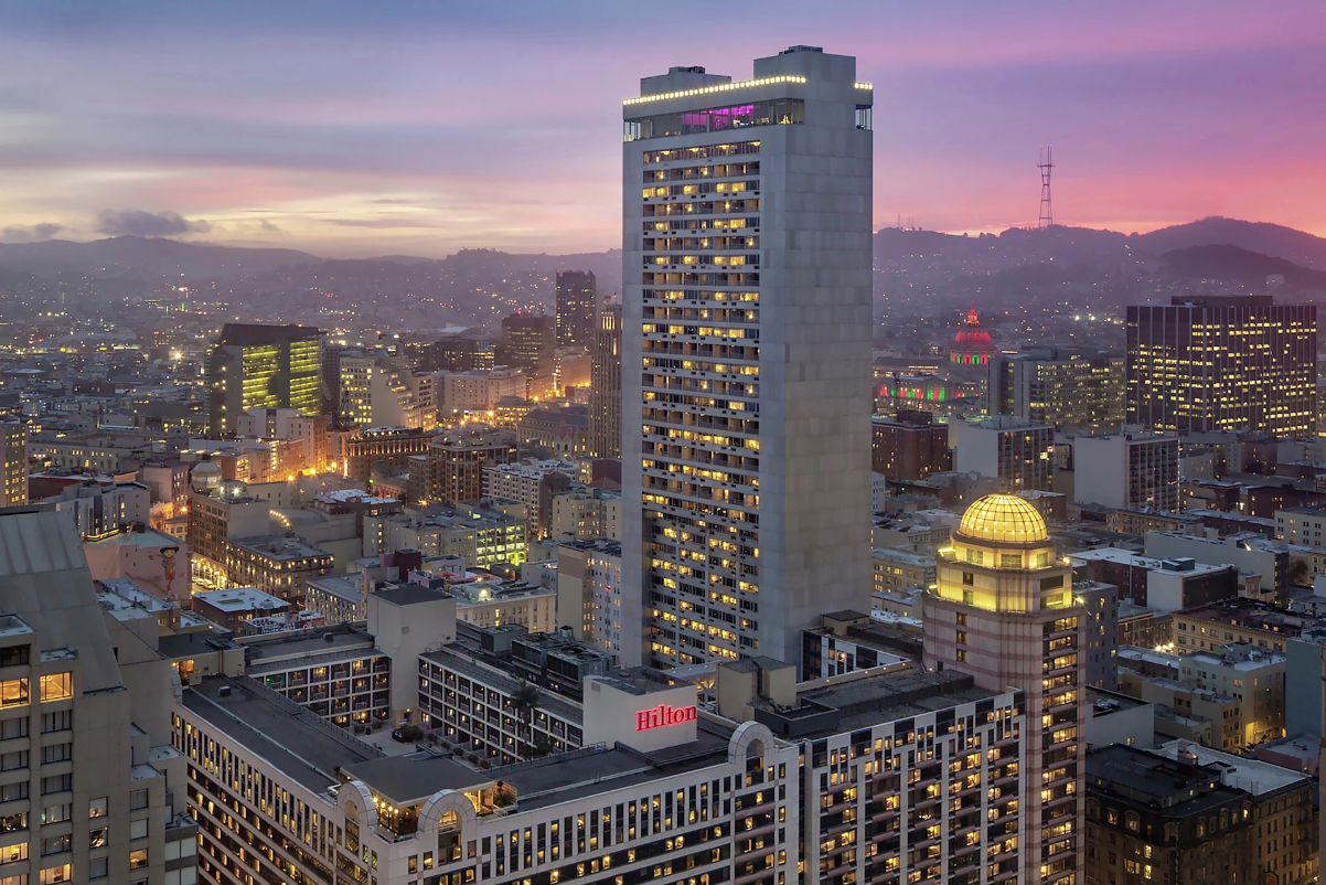 drone image of the exterior of the Hilton San Francisco Union Square Hotel at sunset