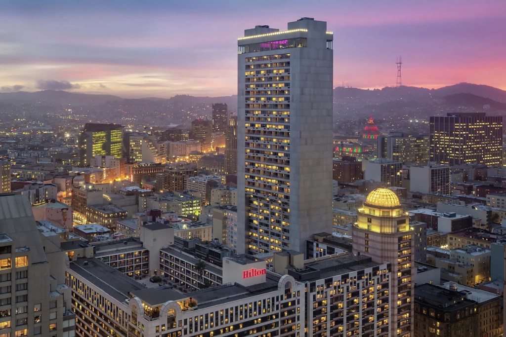 drone image of the exterior of the Hilton San Francisco Union Square Hotel at sunset