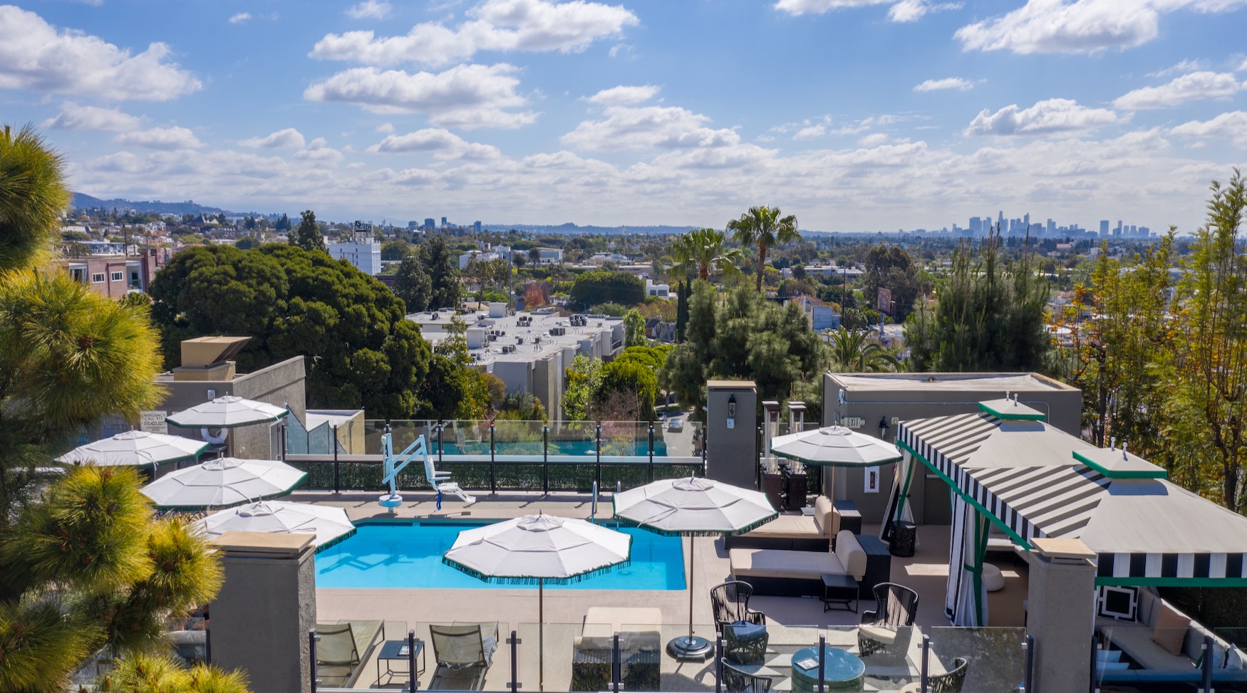 Image of the rooftop pool at a hotel in West Hollywood, looking out over the skyline on a sunny day.