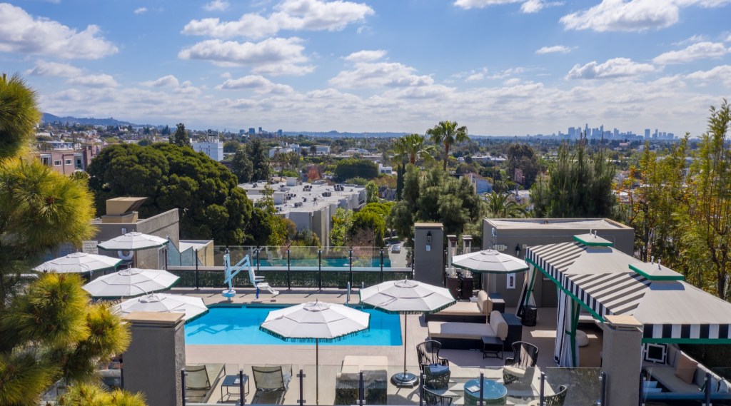 Image of the rooftop pool at a hotel in West Hollywood, looking out over the skyline on a sunny day.